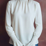 Elegant High Neck White Blouse With Smocked Cuffs And Ruffle Details