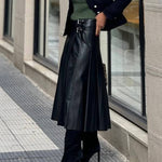Metal buckle-embellished mid-length A-line leather skirt