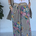 Set of green jacket and wide trousers with floral print