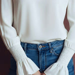 Elegant High Neck White Blouse With Smocked Cuffs And Ruffle Details