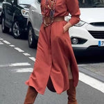 Satin shirt dress with a fitted waist and side slit.